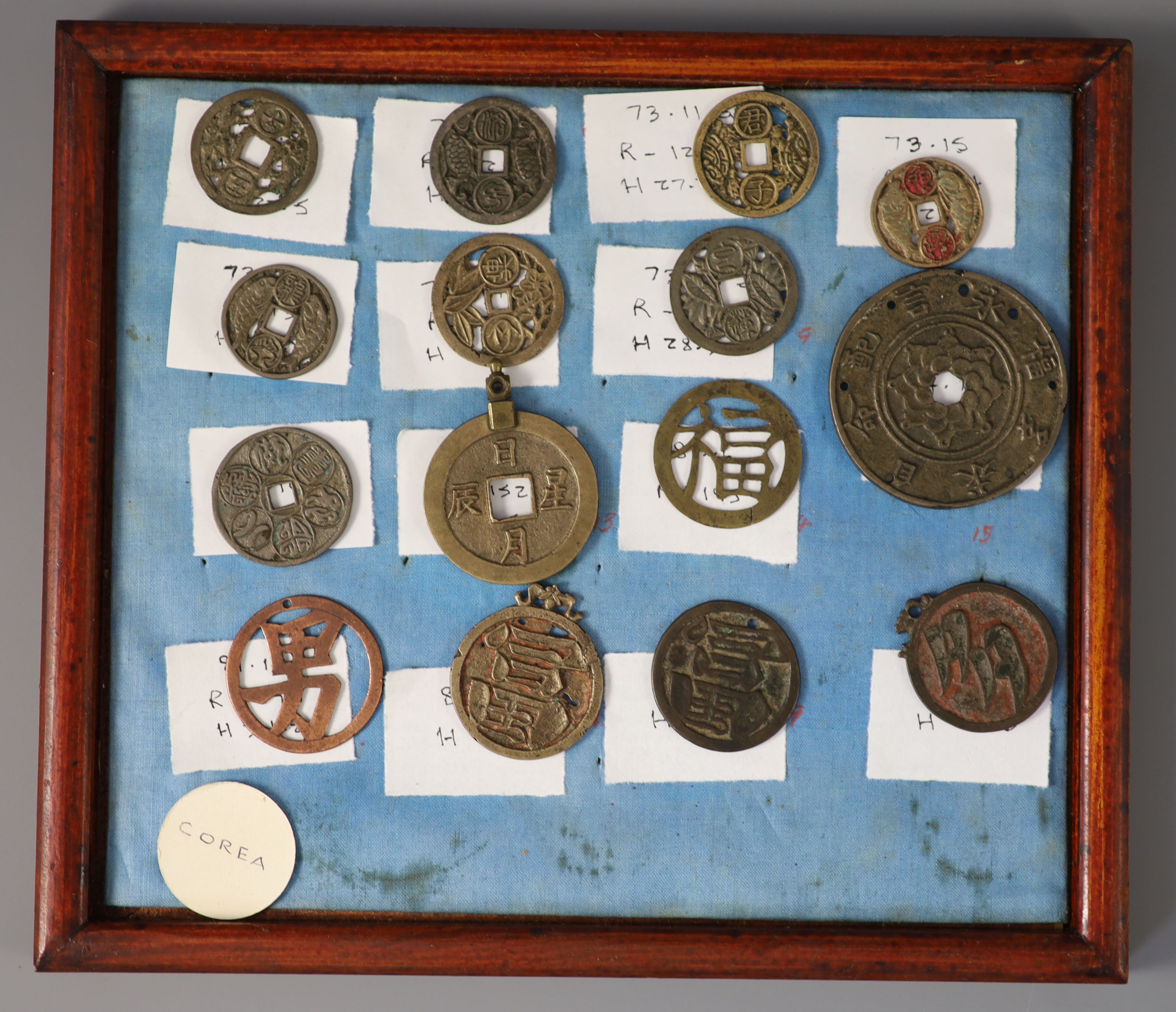 A group of 99 Korean bronze and metal amulets or charms, 19th/20th century